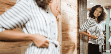 Royal City Nursery - Tsuga Boutique-woman trying on shirt in dressing room